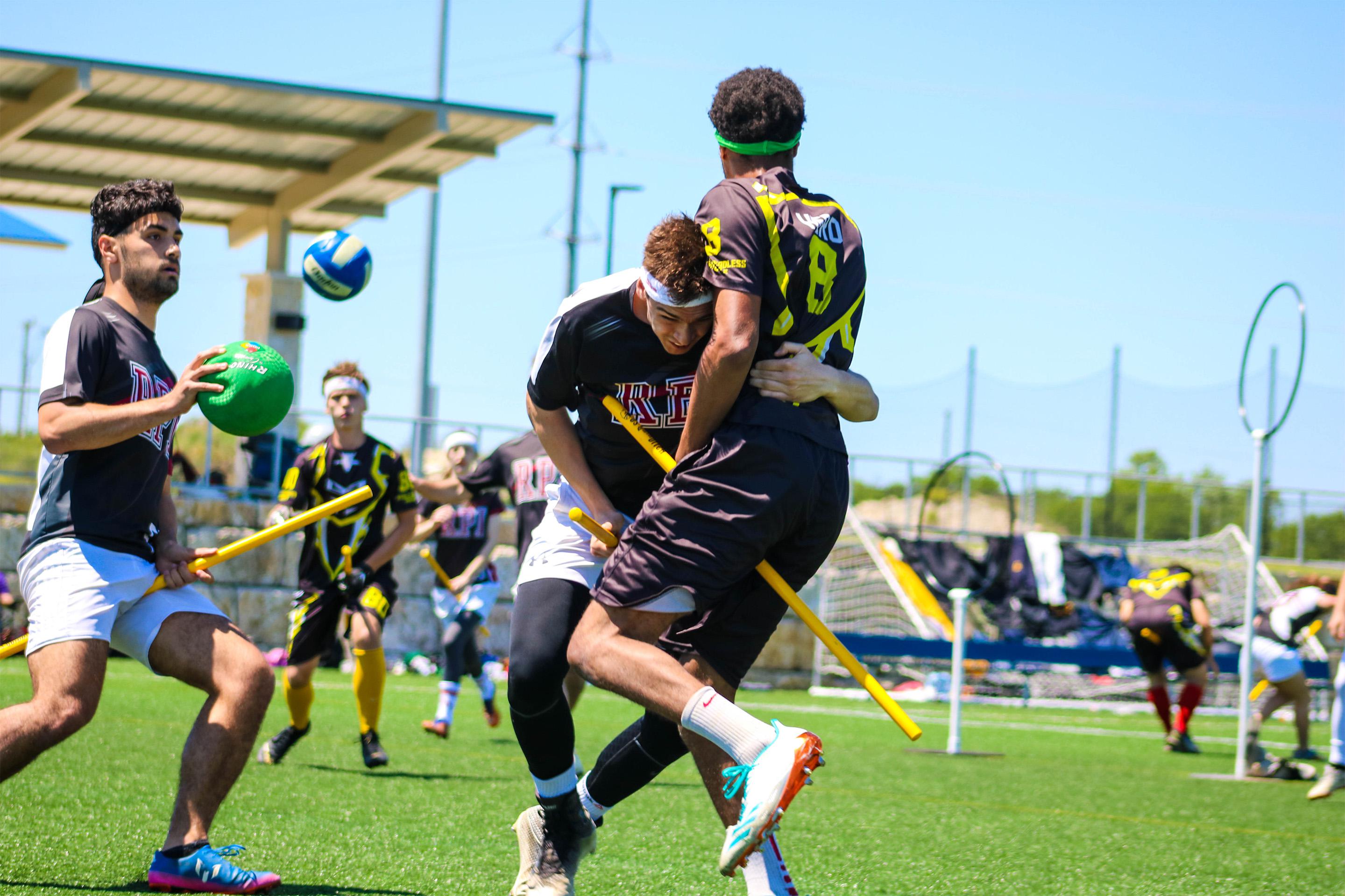 A beater collides with a chaser in an attempt to disrupt a pass. 
