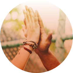 Two hands high-fiving.