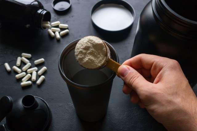 male athlete makes a protein cocktail