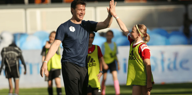 Coach giving youth athlete high five soccer player