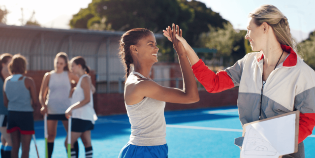 Athlete and coach high five