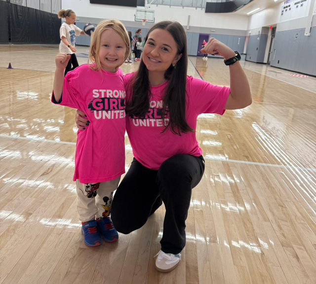 Youth athlete and mentor flexing